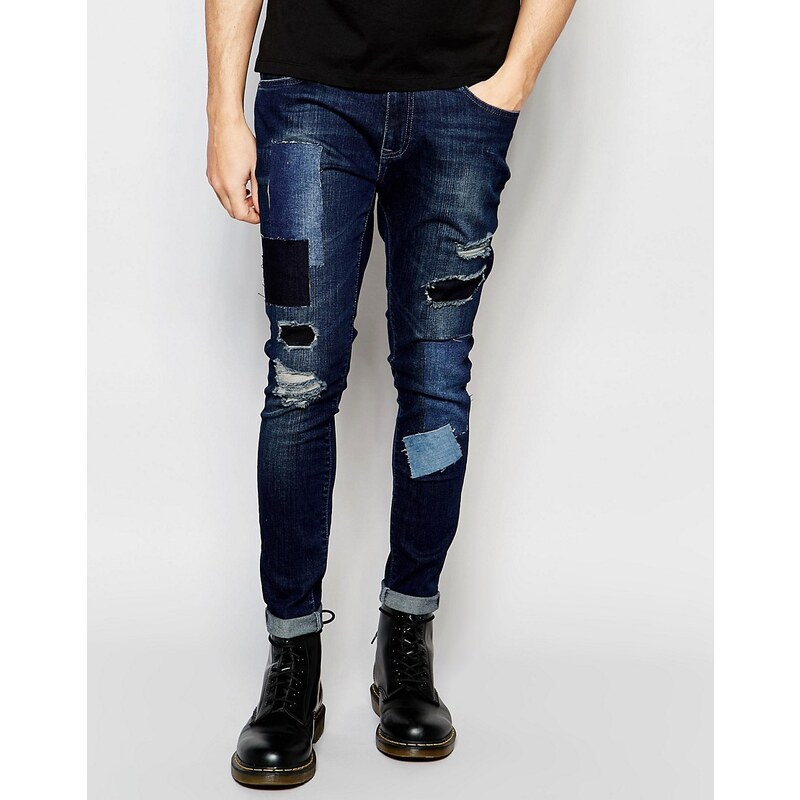 Brooklyn Supply Co - Skinny-Jeans in mittlerer Repair-Waschung mit Aufnähern im Distressed-Look - Blau