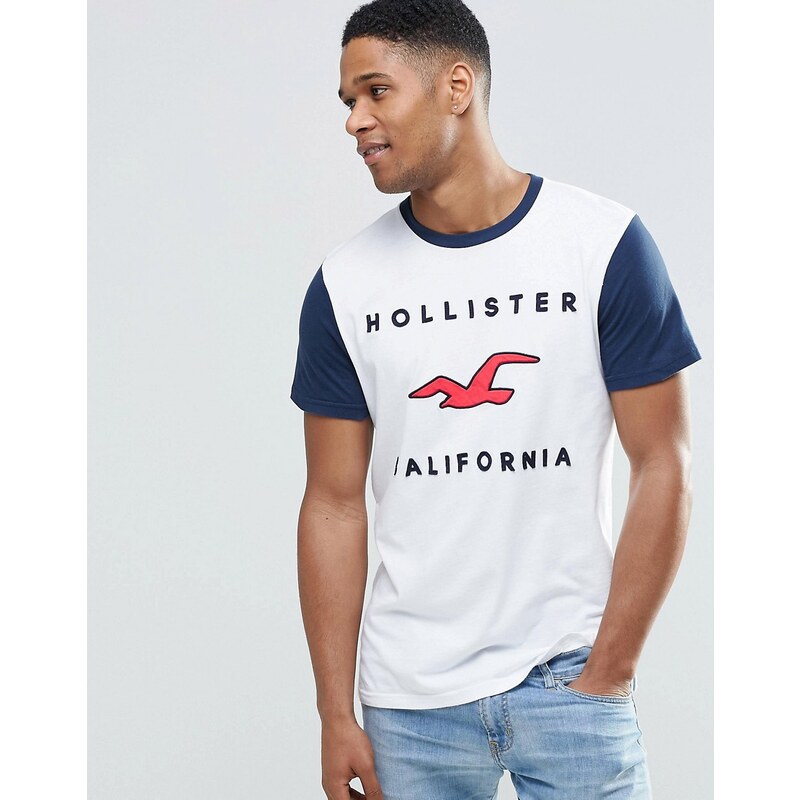 Hollister - Schmales Muskel-T-Shirt mit Retro-Logo & Ringerrücken in Weiß - Weiß
