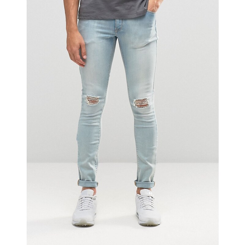 ASOS - Extrem enge Skinny-Jeans in ausgeblichenem Blau mit Zierrissen am Knie - Blau