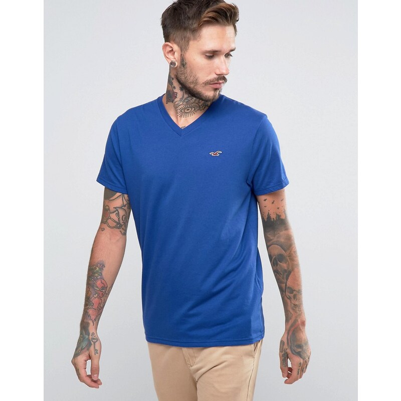 Hollister - Must Have - Schmales T-Shirt mit V-Ausschnitt in Blau mit meliertem Seagull-Logo - Blau
